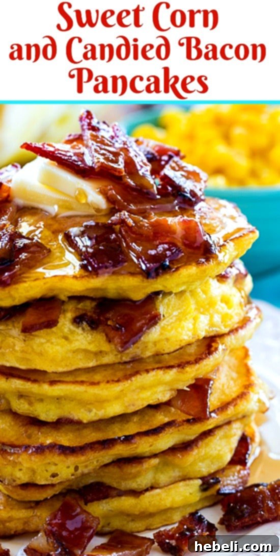 An appetizing close-up of a stack of fluffy Sweet Corn and Candied Bacon Pancakes, topped with maple syrup and whipped cream, garnished with fresh mint.
