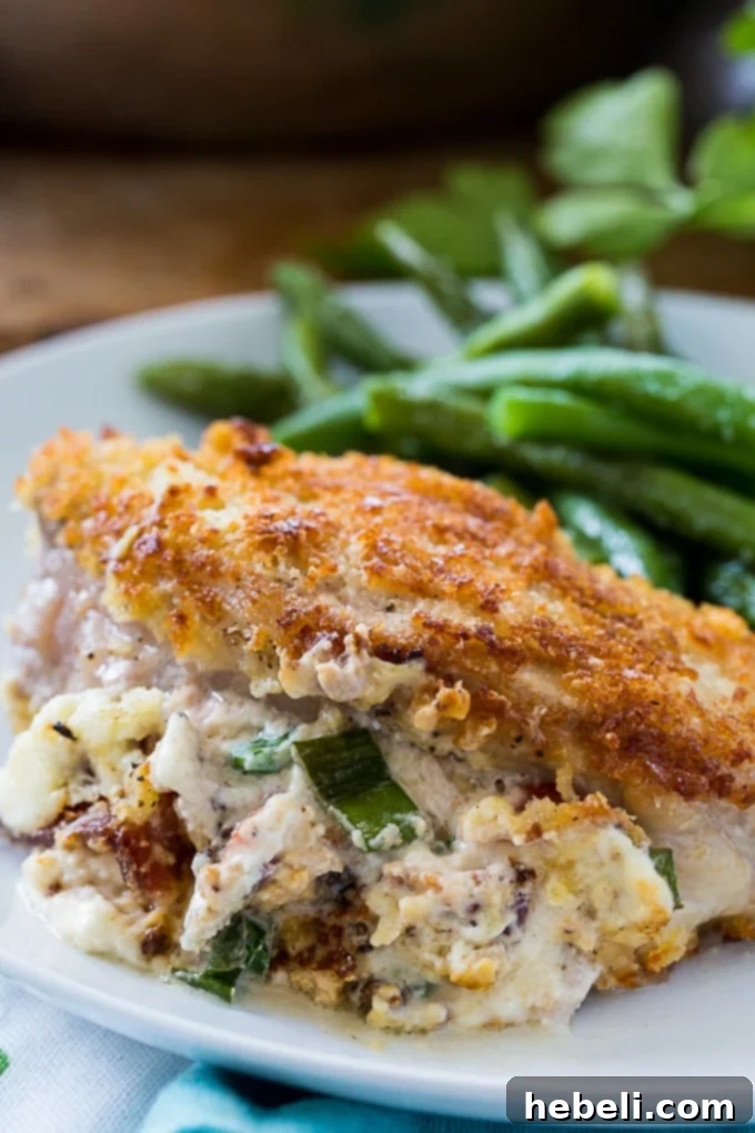 Close-up of a pan-fried Garlic Parmesan Stuffed Pork Chop before oven baking.
