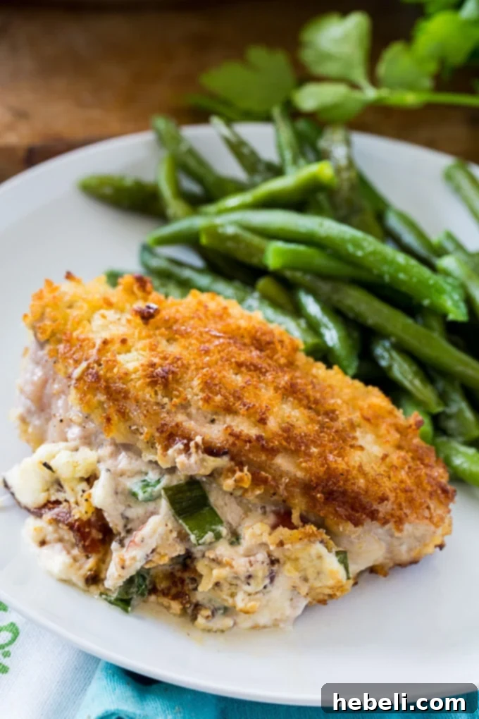 A plated Garlic Parmesan Stuffed Pork Chop with sides, ready to be enjoyed.