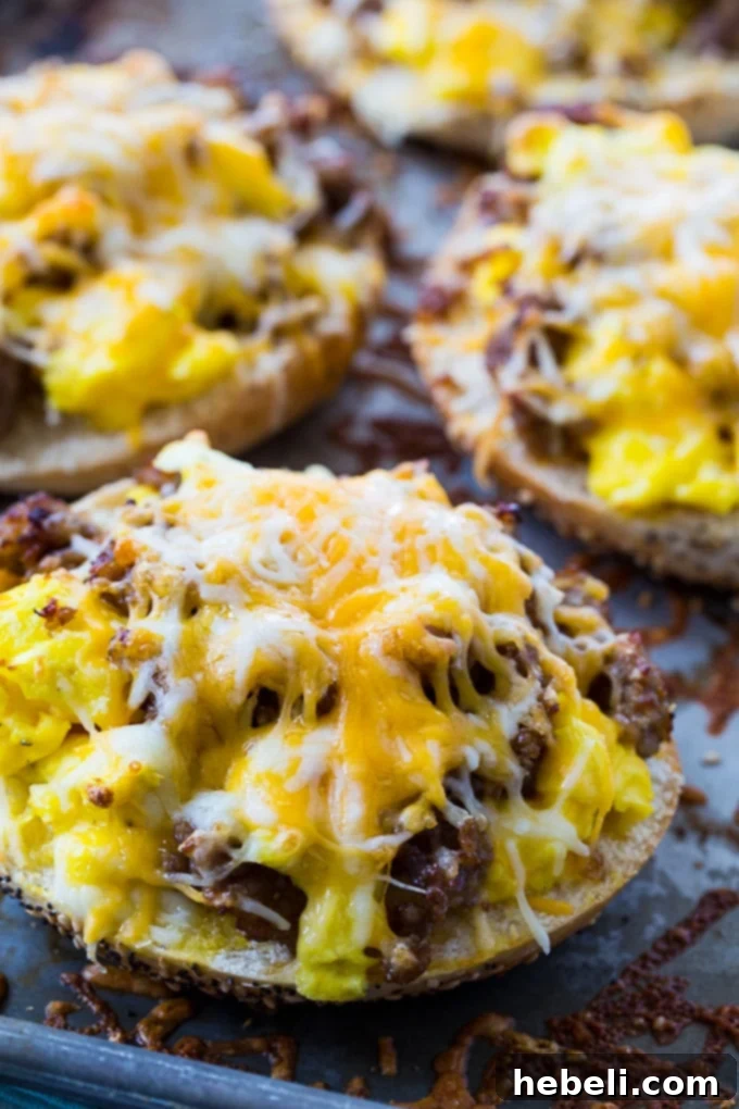 Stack of golden brown Sausage, Egg & Cheese Breakfast Bagel Pizzas, perfectly cooked and ready to serve