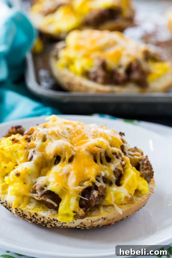 Close-up shot of a Sausage, Egg & Cheese Bagel Pizza garnished with fresh herbs, showcasing its rich toppings