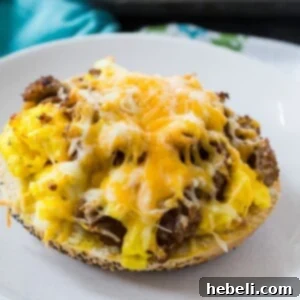 Close-up of a cooked Sausage, Egg & Cheese Bagel Pizza, with bubbly melted cheese and crispy edges