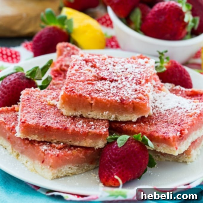 Zesty Strawberry Lemonade Bars 2 Delicious Strawberry Lemonade Bars on a cooling rack, ready to be served.