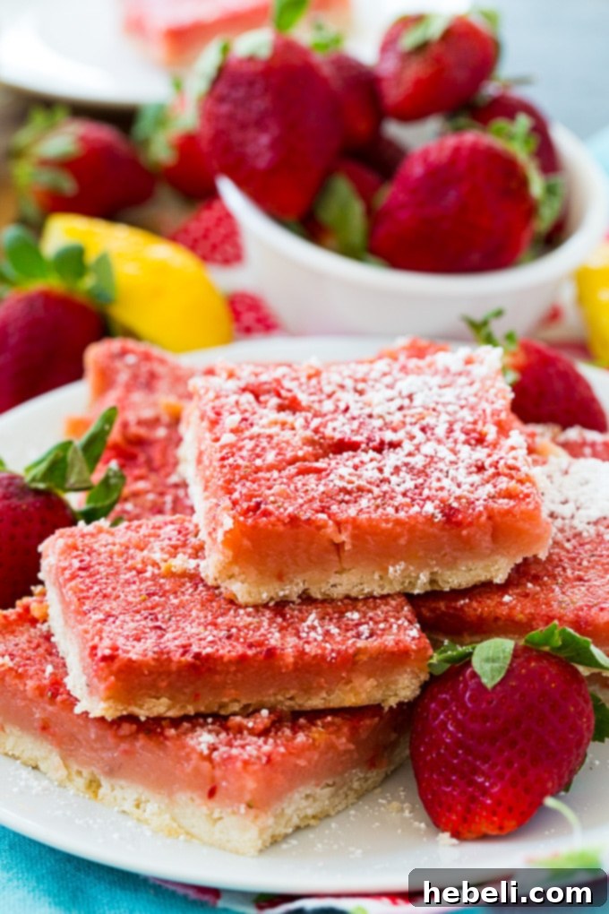 Zesty Strawberry Lemonade Bars 3 Close-up of a cut Strawberry Lemonade Bar showing the layers of crust and filling.