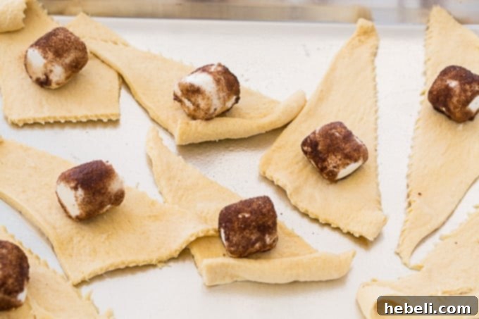 Miracle Morning Rolls 4 Close-up of marshmallows on crescent roll dough, ready to be wrapped for Resurrection Rolls.