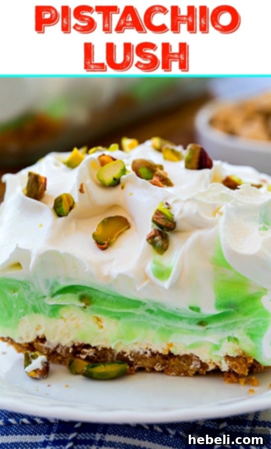 Pistachio Lush dessert in a serving dish, showing a perfectly cut slice ready to be lifted out
