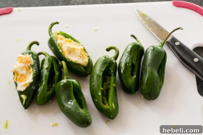 Stuff the jalapenos with cream cheese mixture.