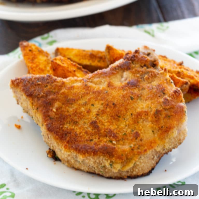 Crispy Ranch Seasoned Fried Pork Chops, golden brown and perfectly cooked on a plate, ready to be served
