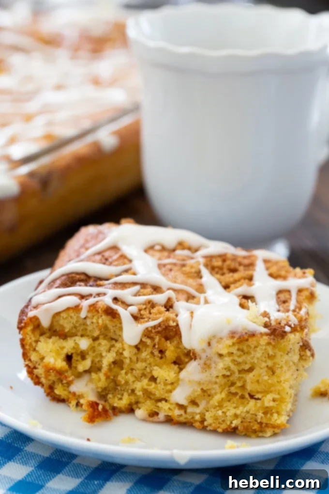 A golden brown Vintage Coffee Cake, freshly baked, on a cooling rack before glazing.