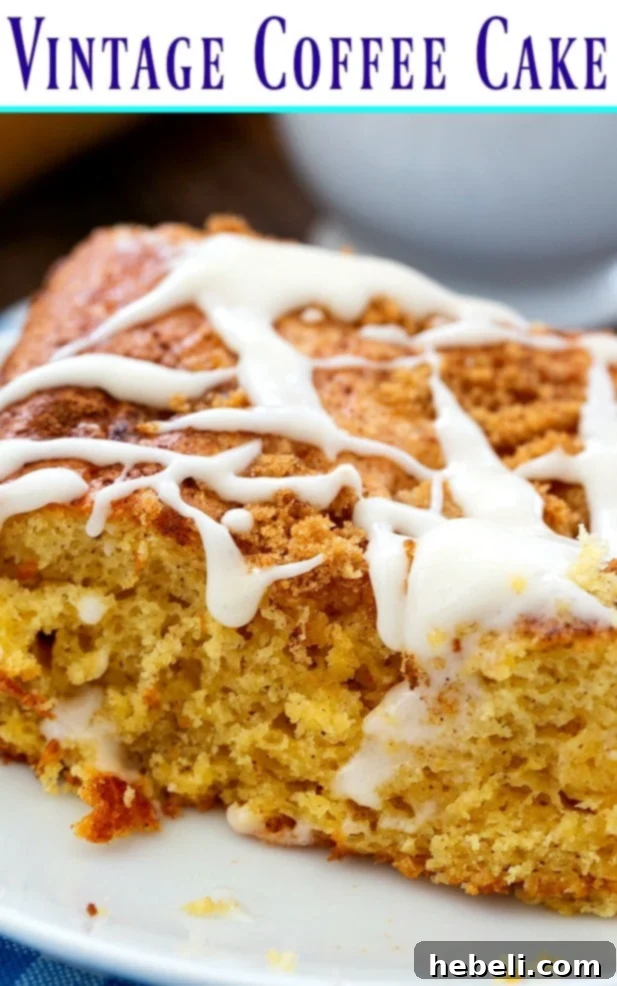 Beautifully glazed Vintage Coffee Cake ready to be served, with a slice already cut and revealing the cinnamon layers. Perfect for a cozy breakfast.