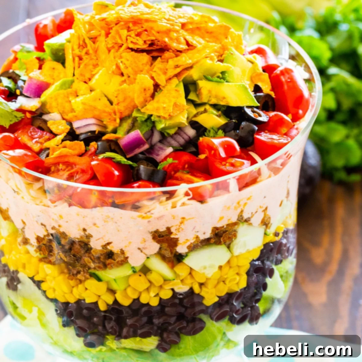 Stacked Taco Salad 2 Beautifully arranged Layered Taco Salad in a clear trifle bowl, showcasing all the vibrant layers.