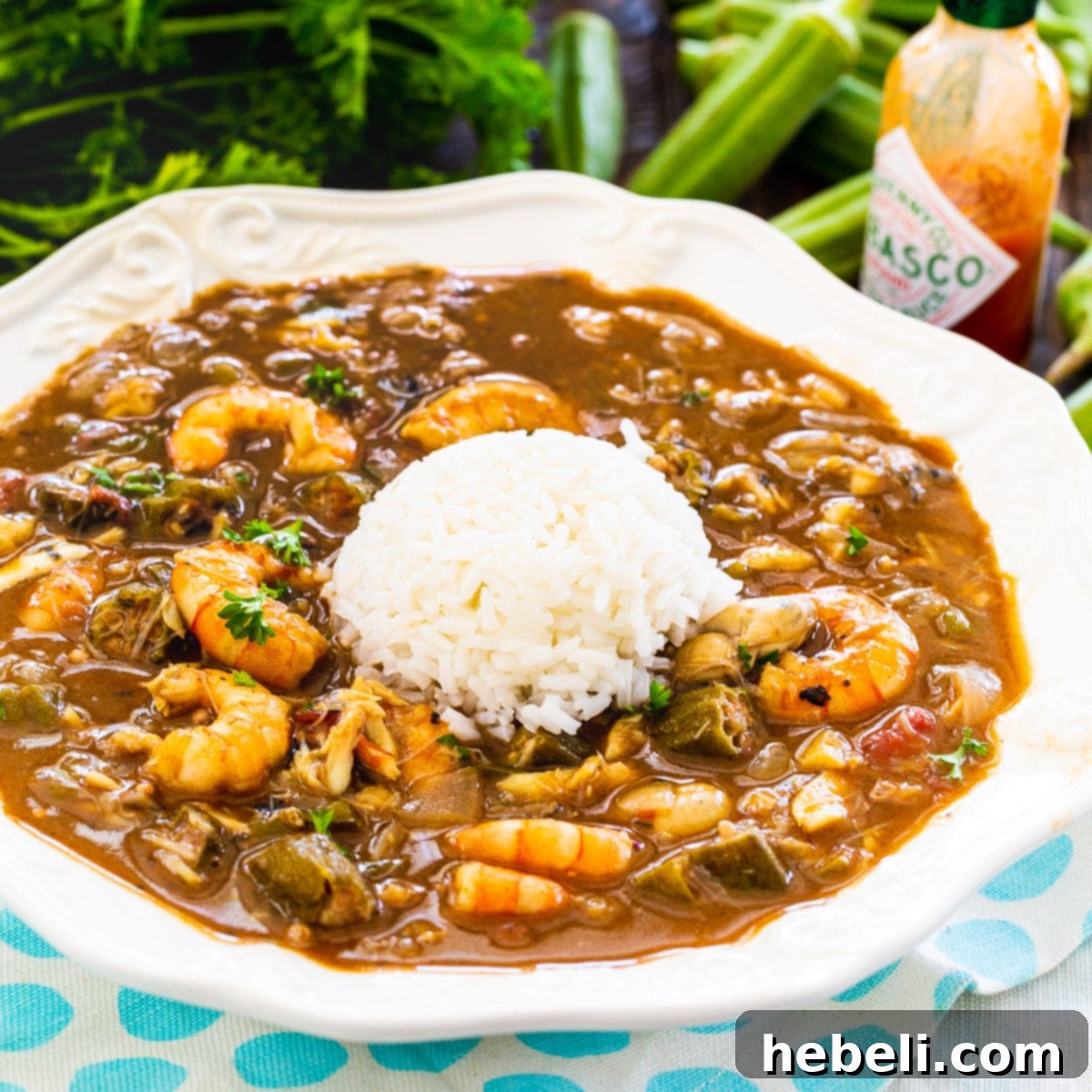 Southern Seafood and Okra Gumbo 2 A hearty bowl of Seafood and Okra Gumbo served with a mound of fluffy white rice, ready to be enjoyed.