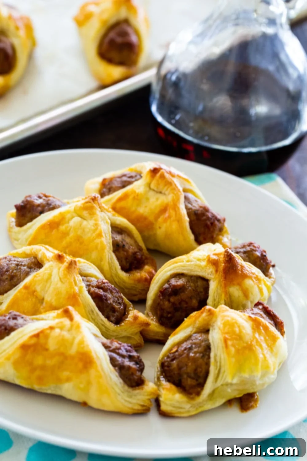 A plate of freshly baked Breakfast Pigs in a Blanket, ready to be enjoyed.