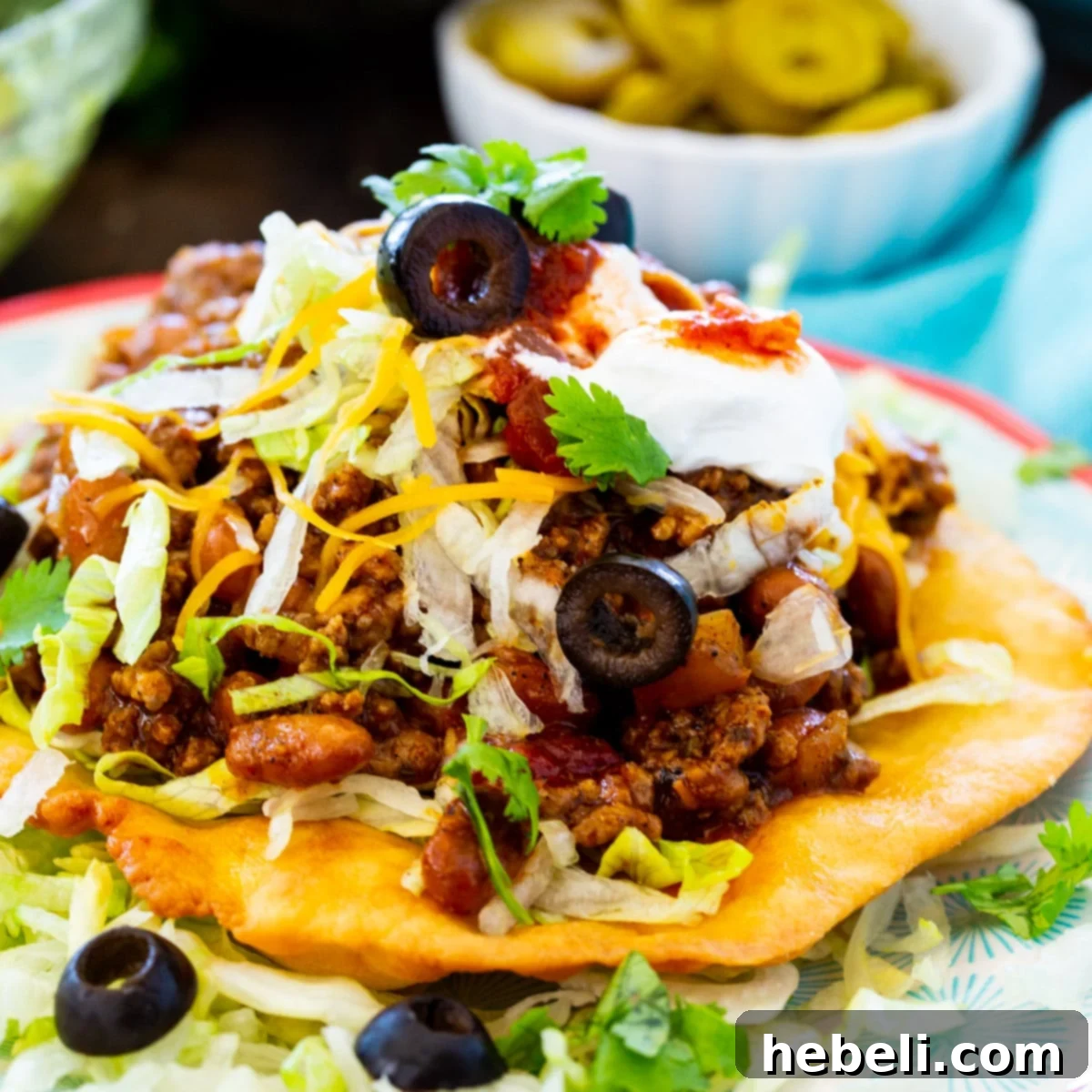 Ultimate Fry Bread Tacos 2 A delicious Fry Bread Taco on a plate, showcasing its golden-brown bread and abundant toppings.