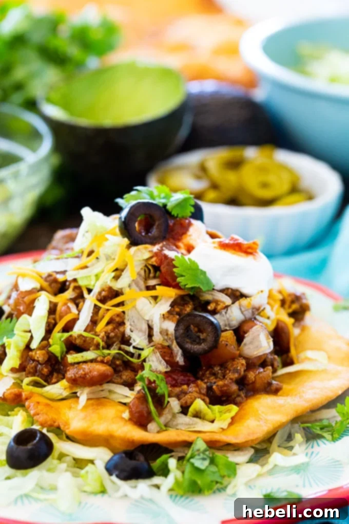 Ultimate Fry Bread Tacos 4 A close-up shot of several Fry Bread Tacos, showing their rich fillings and vibrant toppings.