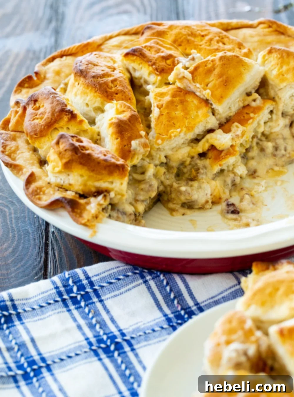 Homestyle Gravy & Biscuit Pie 5 Unbaked Biscuits and Gravy Pie filling the pie pan, with biscuits arranged neatly on top, ready for the oven.