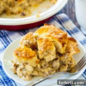 Homestyle Gravy & Biscuit Pie 6 A delicious slice of Biscuits and Gravy Pie on a plate, featuring a crispy crust and creamy gravy.