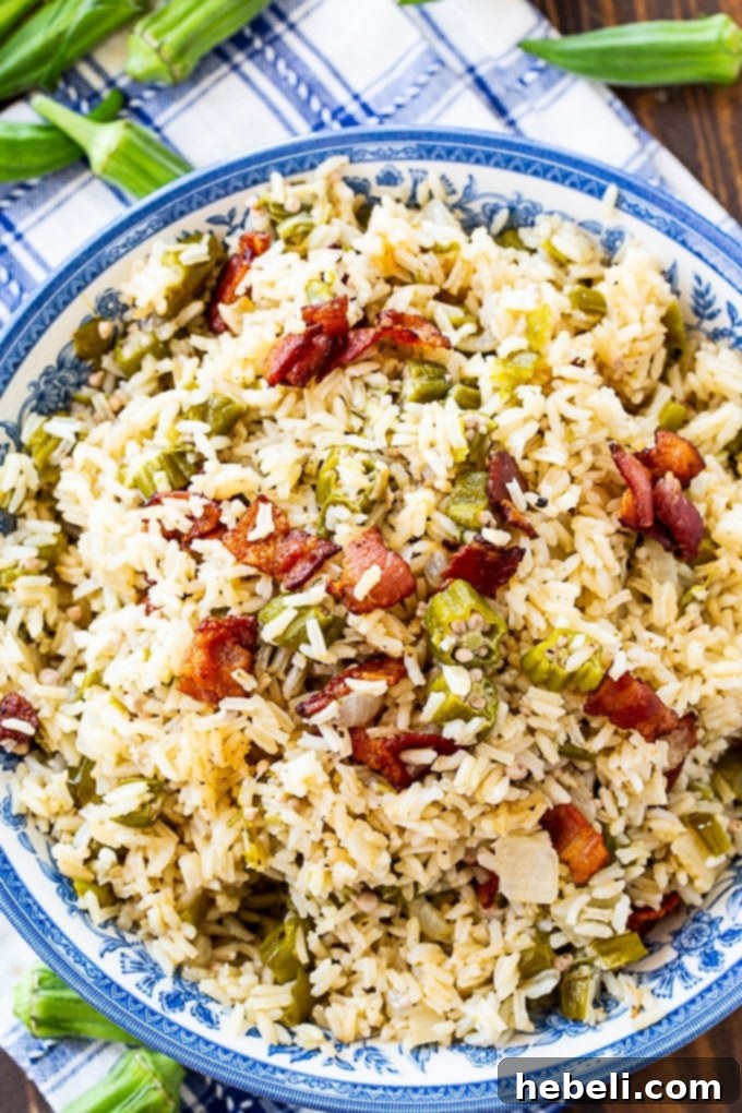 A close-up of Okra Pilau, highlighting the textures of rice, okra, and finely diced vegetables.