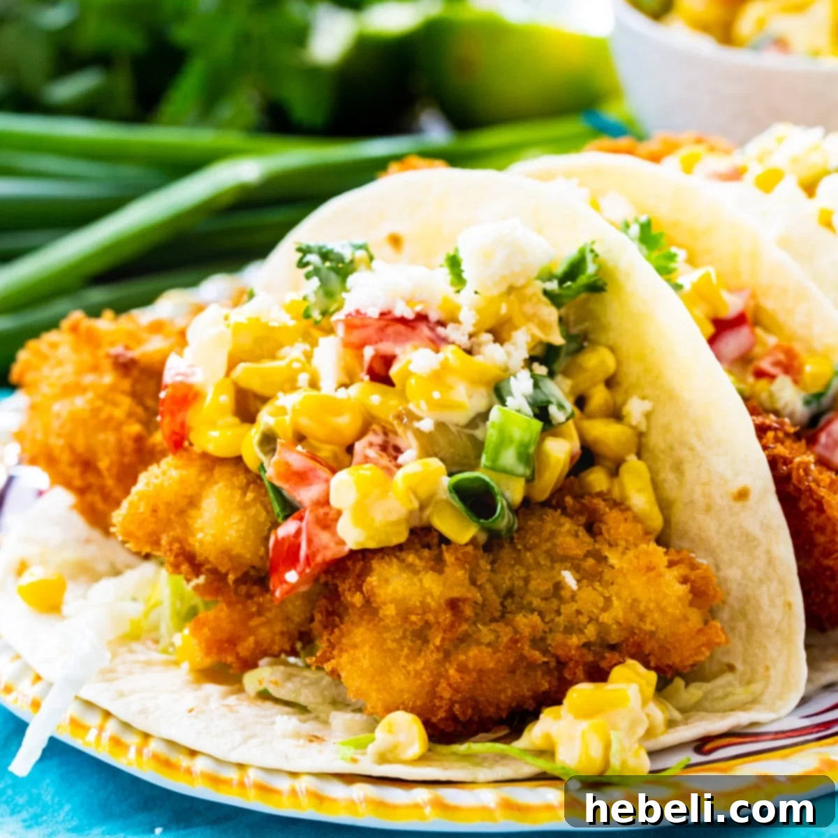 Crispy Catfish Tacos with Tequila Spiked Creamed Corn 2 Crunchy Catfish Tacos on a plate, garnished with fresh cilantro.