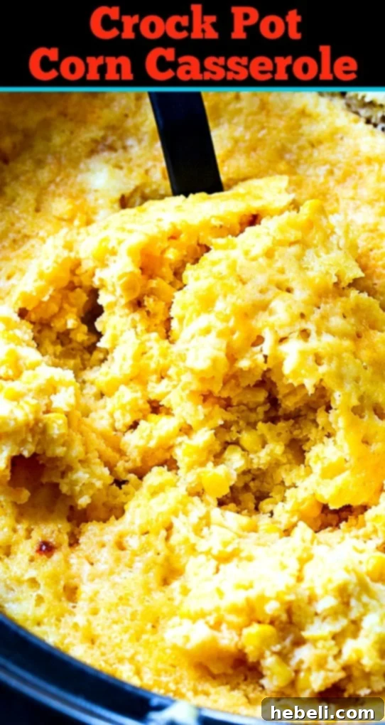 The golden-brown and bubbling surface of a delicious Crock Pot Corn Casserole, still warm in the 6-quart slow cooker, ready for immediate serving.