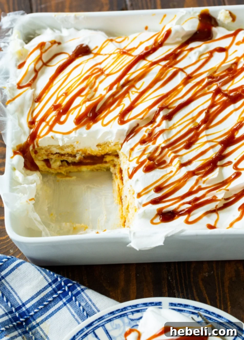 No-Bake Salted Caramel Ritz Cracker Delight 5 Caramel Ritz Cracker Icebox Dessert in a baking dish with a piece already cut out and served.