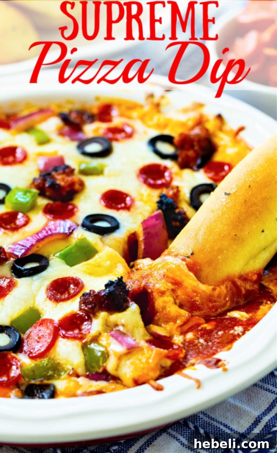 Close-up of Supreme Pizza Dip showing the rich, melted cheese and vibrant toppings, ready to be served at a party.
