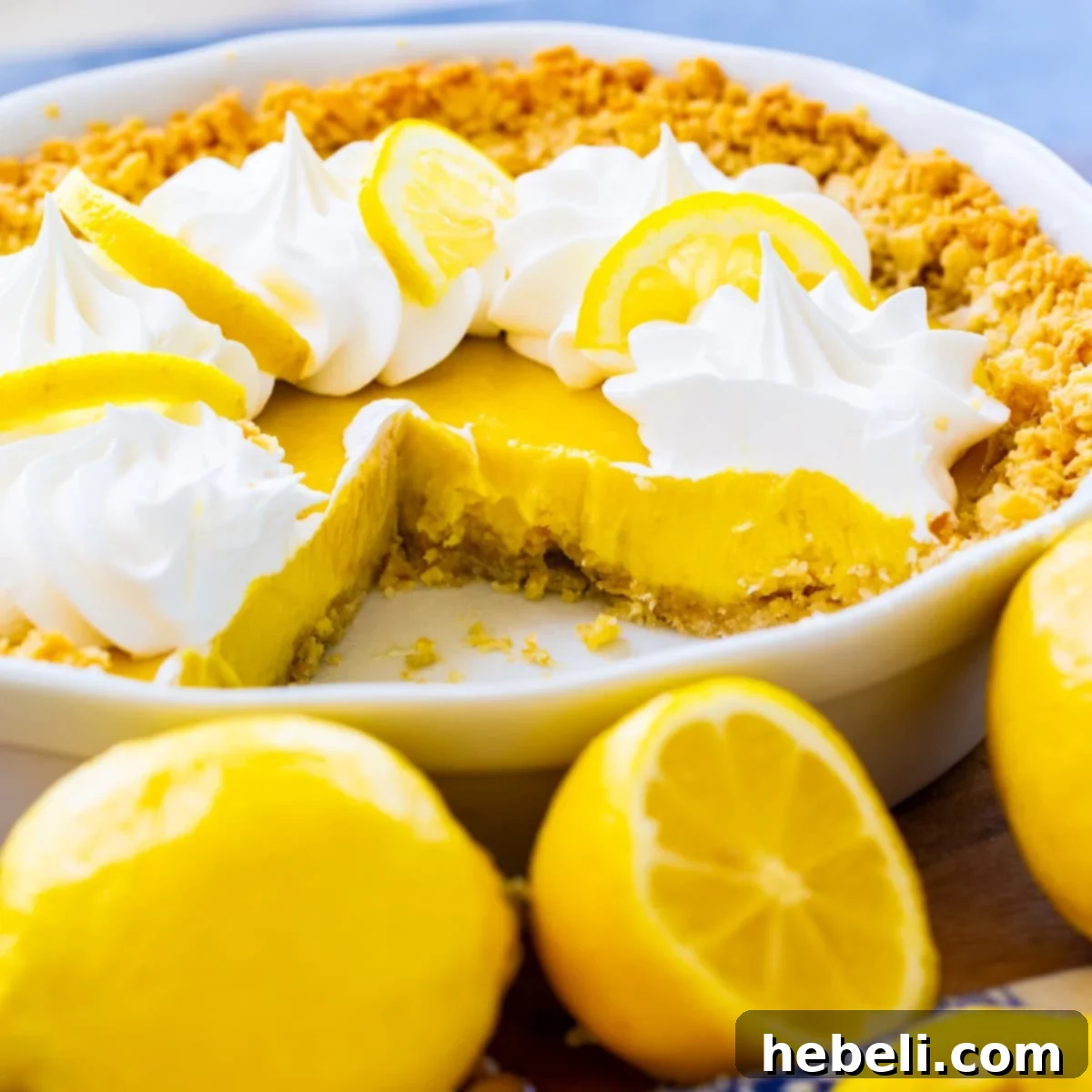 A vibrant Atlantic Beach Pie with a slice carefully removed, showcasing its creamy lemon filling and distinctive cracker crust.