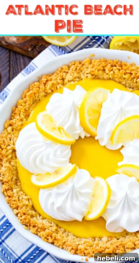 A slice of Atlantic Beach Pie featuring its distinct layers of salty cracker crust, tangy lemon custard, and fluffy whipped cream, indicating a perfect Southern dessert.