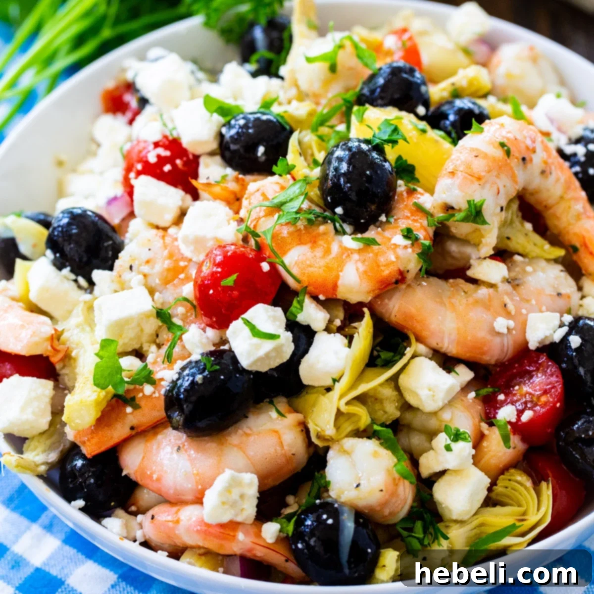Zesty Italian Marinated Shrimp 2 A large bowl of vibrant Italian Marinated Shrimp, showcasing fresh ingredients like tomatoes, olives, and herbs.