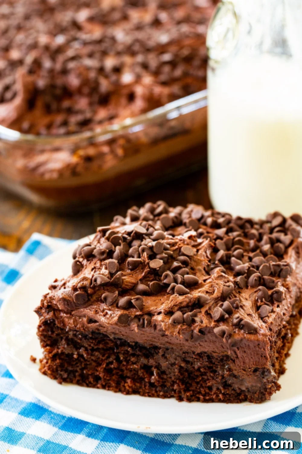 Slice of poke cake on a small white plate.