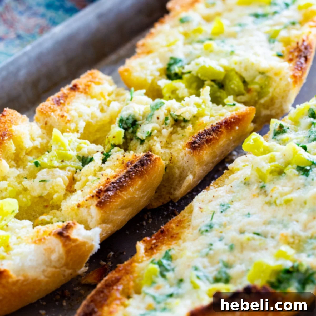 Two golden loaves of crispy Pepperoncini Garlic Bread, freshly baked and ready to serve.