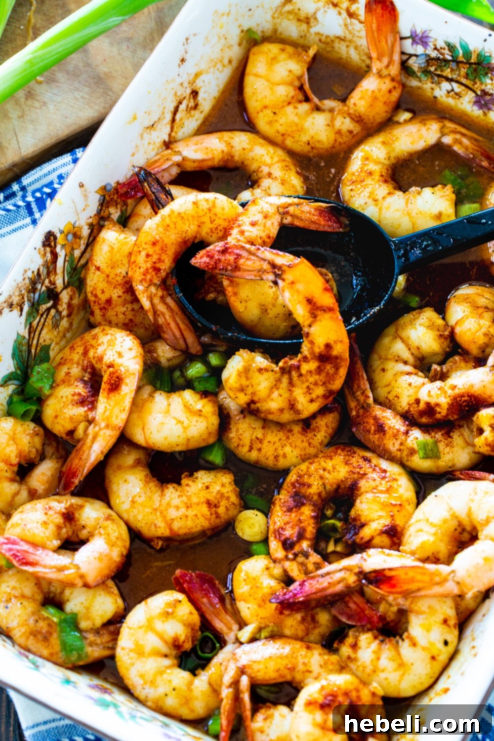Cajun Honey Shrimp Bake 3 Close-up shot of perfectly baked honey Cajun shrimp, glistening with marinade, in a baking dish.