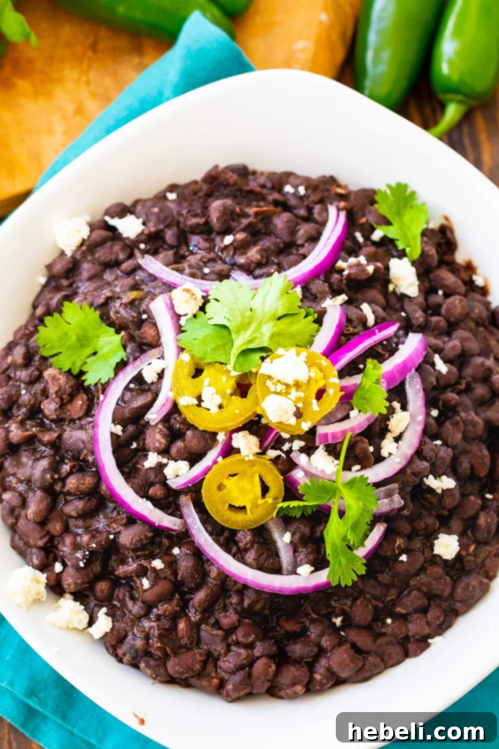 Bold & Spicy Black Beans 4 Overhead of Black Beans topped with jalapenos, cilantro and red onion.