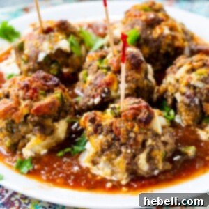 Jalapeno Popper Meatballs on a plate with toothpicks stuck in them.