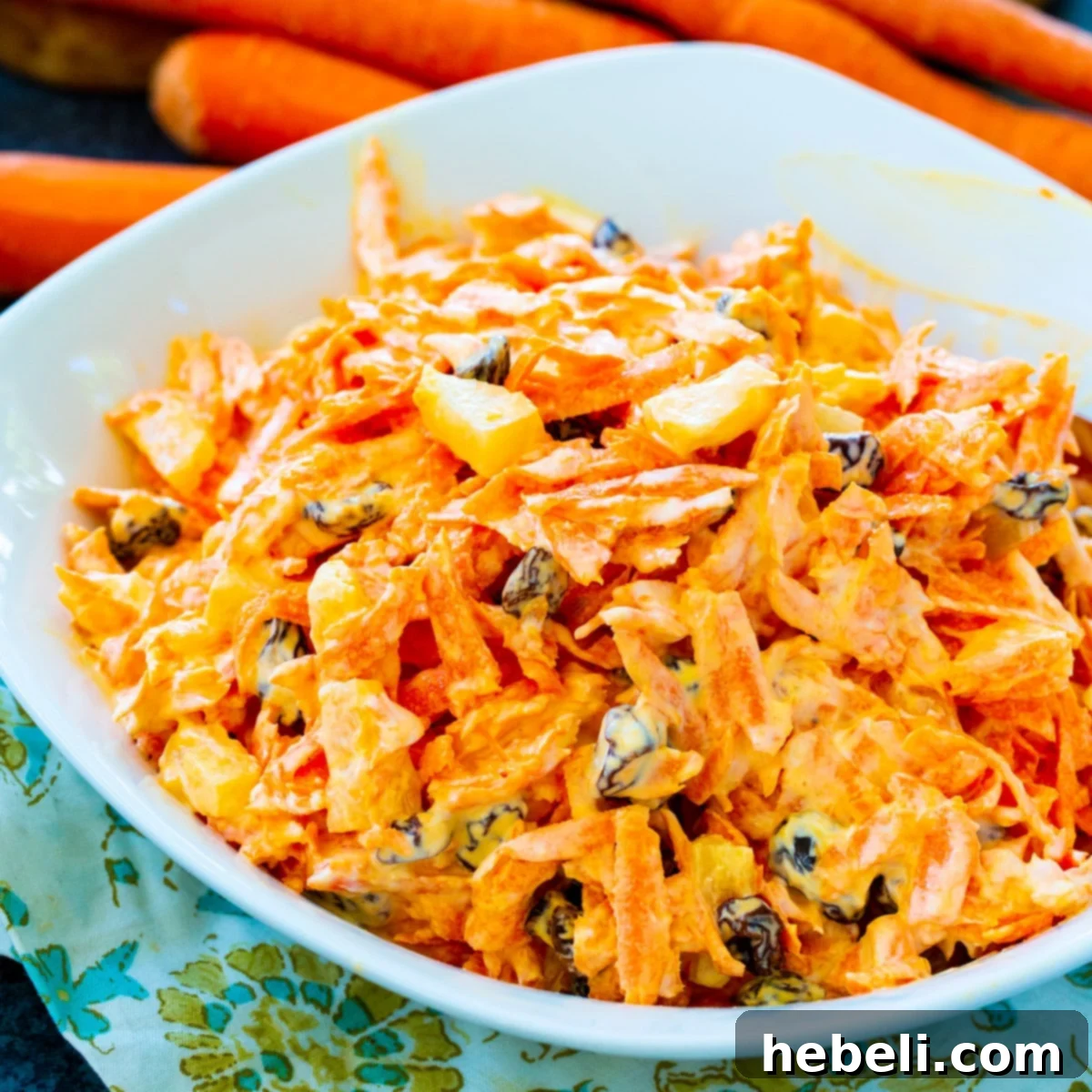 Sunshine Carrot Raisin Salad 2 Freshly made Carrot Raisin Salad in a pristine white bowl, ready to be served.