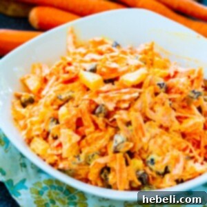 Sunshine Carrot Raisin Salad 5 Carrot Raisin Salad in a white bowl.