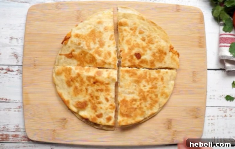 A delicious quesadilla, perfectly cut into four triangular portions, ready to be served.