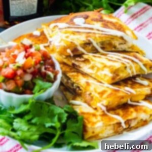 Chicken, Bacon and Ranch Quesadillas cut into triangles and stacked.