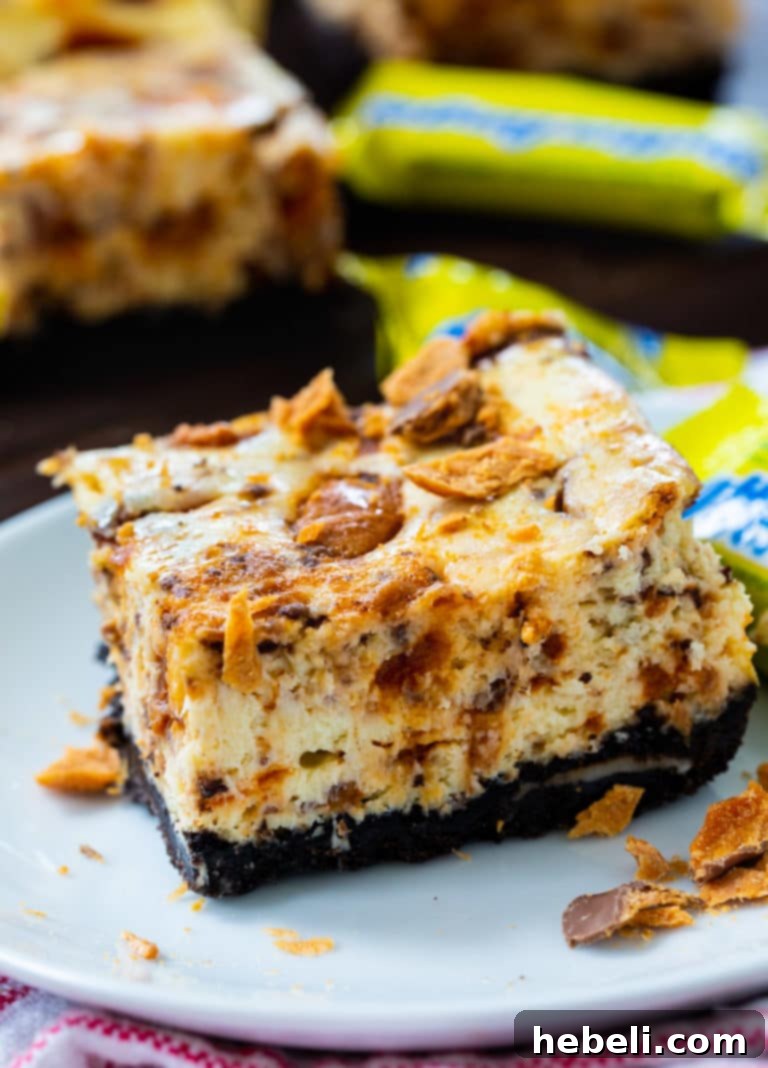 Decadent Butterfinger Cheesecake Bars 5 Stacked Butterfinger Cheesecake Bars, ready to be served.