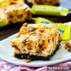Decadent Butterfinger Cheesecake Bars 6 Butterfinger Cheesecake Bars on a plate.