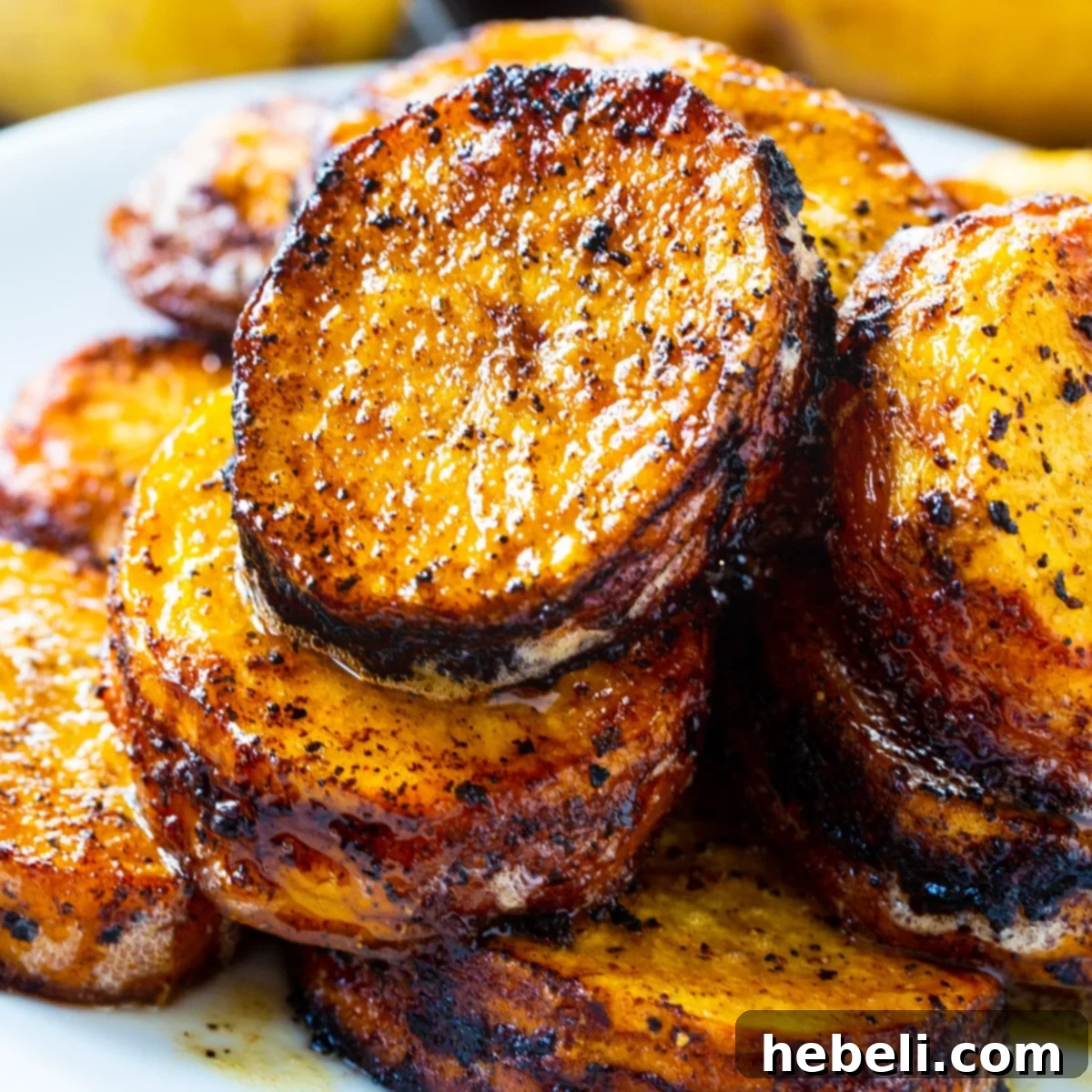Spicy Melting Potatoes piled up on a plate, showcasing their golden-brown crust and vibrant color.