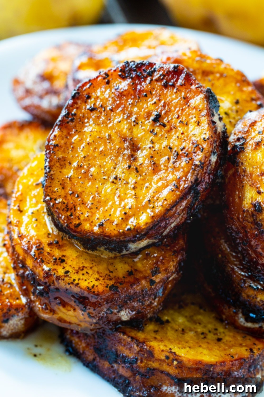 Melting Potatoes stacked on a plate, showing their golden color and inviting texture.