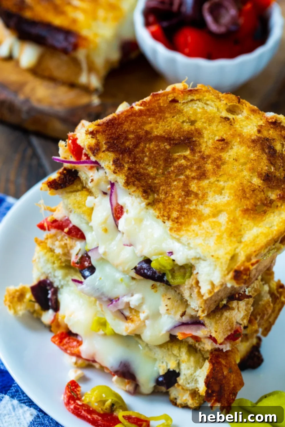 Slices of grilled cheese stacked on a plate.