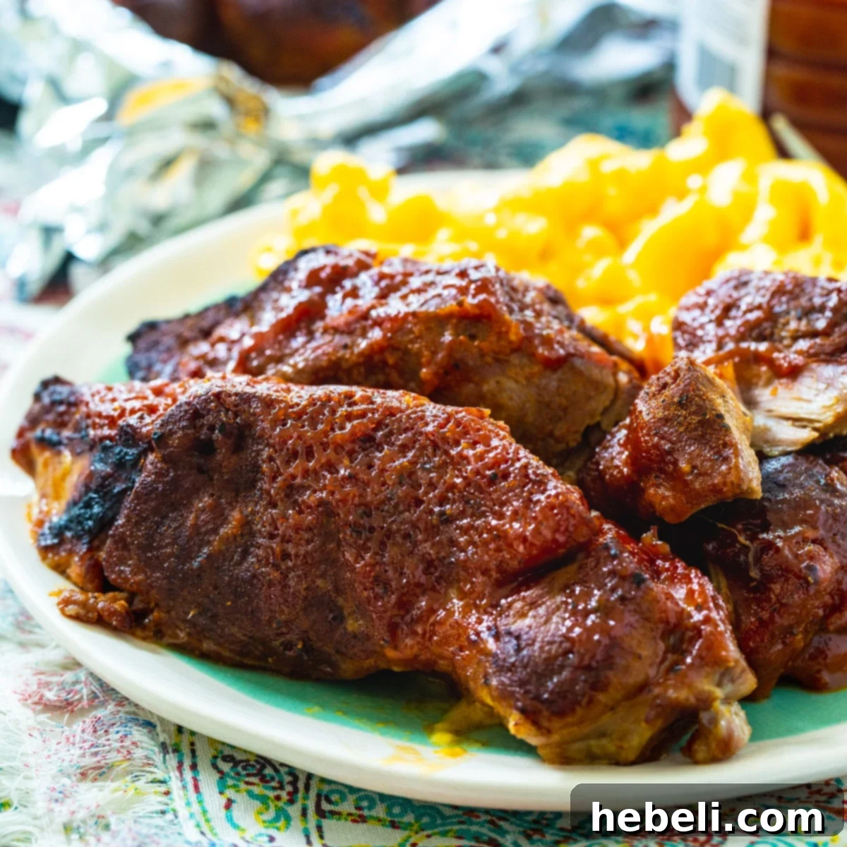Instant Pot Country Style Ribs on plate with mac and cheese, showcasing tender, saucy pork.