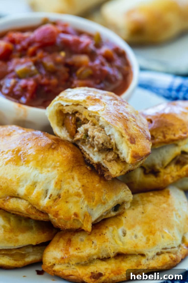 Freshly baked Pork Picadillo Empanadas cooling on a wire rack.