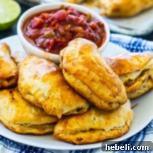 Pork Picadillo Empanadas on a plate with small bowl of salsa.