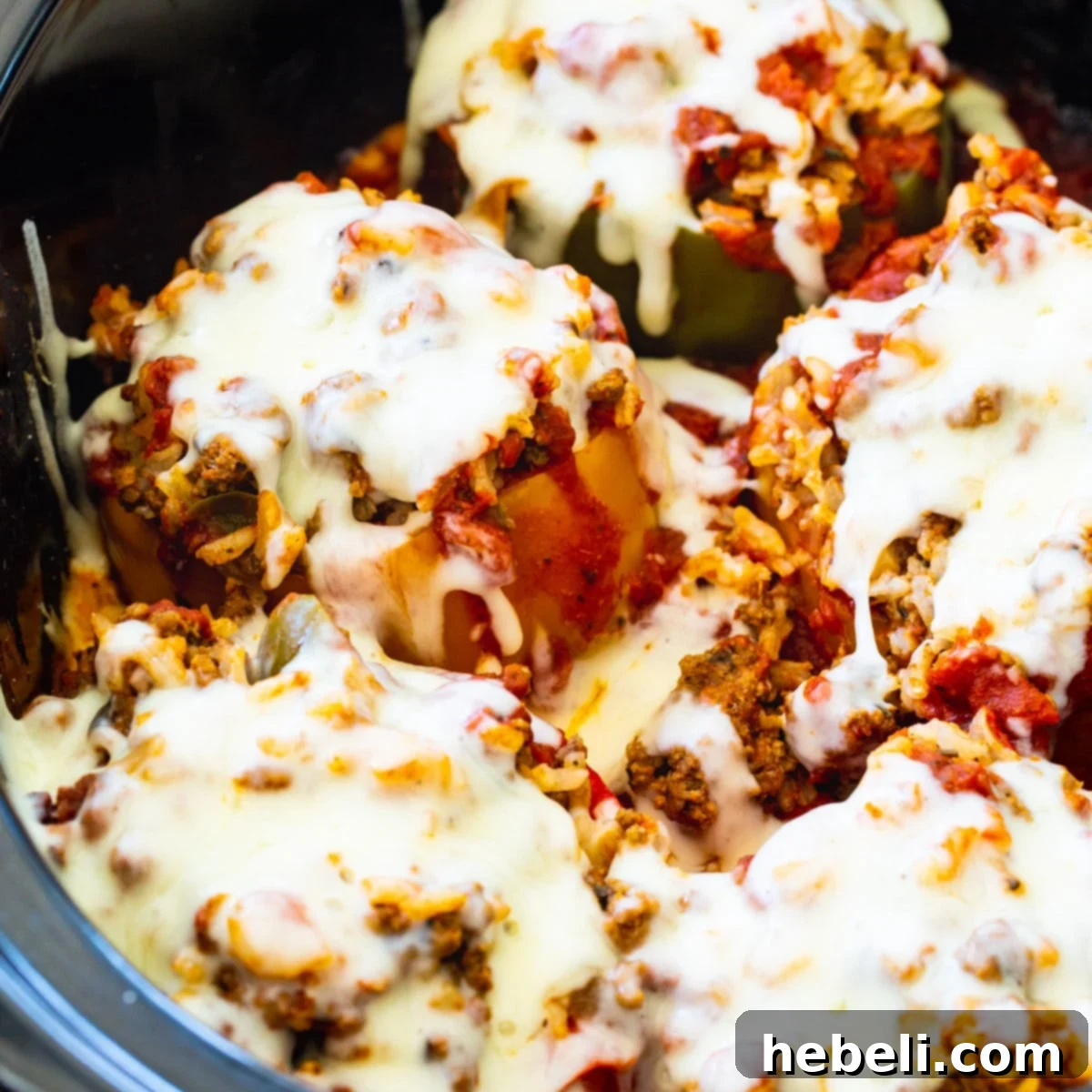 Delicious Slow Cooker Stuffed Peppers nestled in a slow cooker, ready to serve.