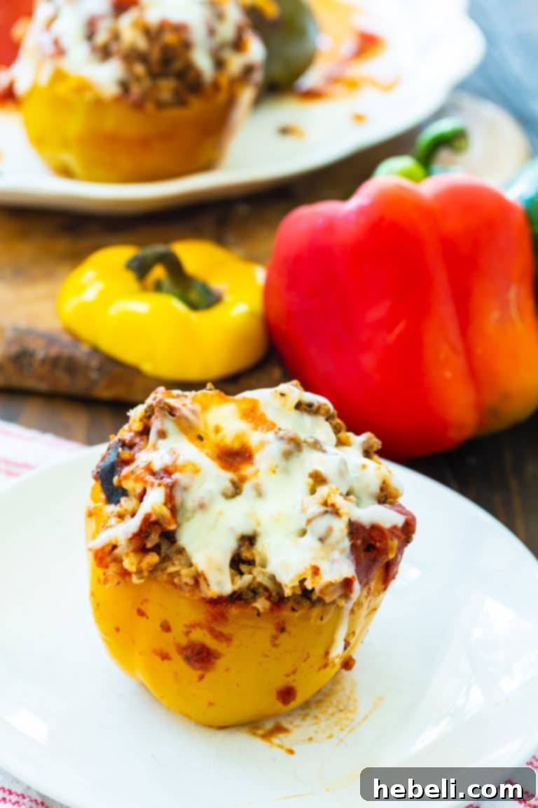 Cooked Slow Cooker Stuffed Peppers, topped with melted mozzarella cheese.