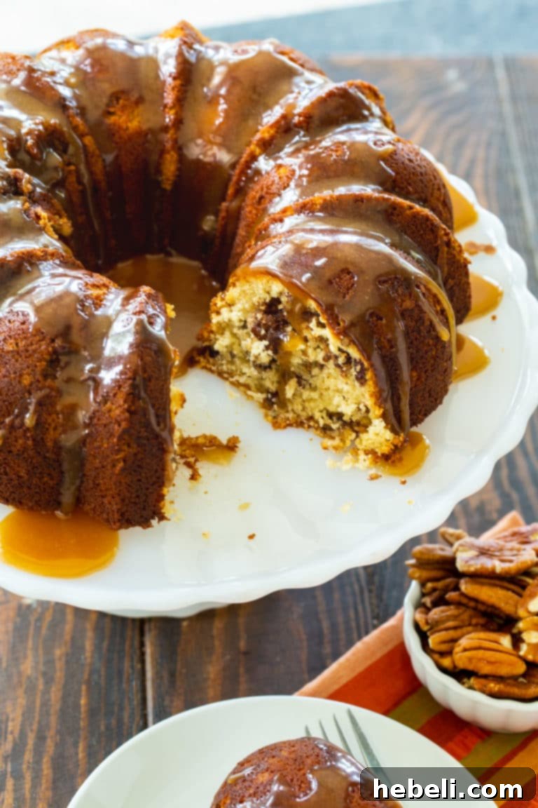 Close-up of a Pecan Pie Bundt Cake drizzled with a rich brown sugar glaze.
