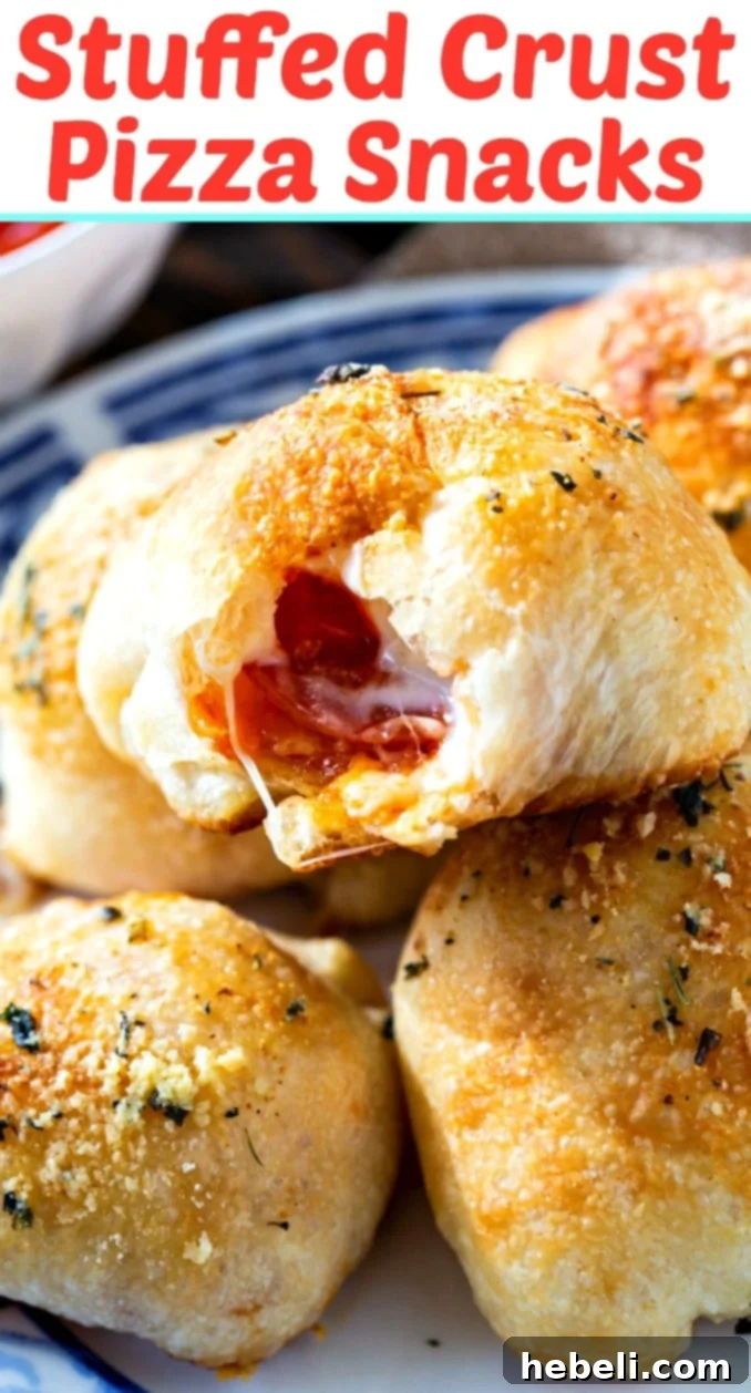 A close-up shot of several baked Stuffed Crust Pizza Snacks, perfectly golden and inviting, ready to be enjoyed as a great gameday snack.